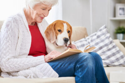 Loving Senior Woman Reading with Dog